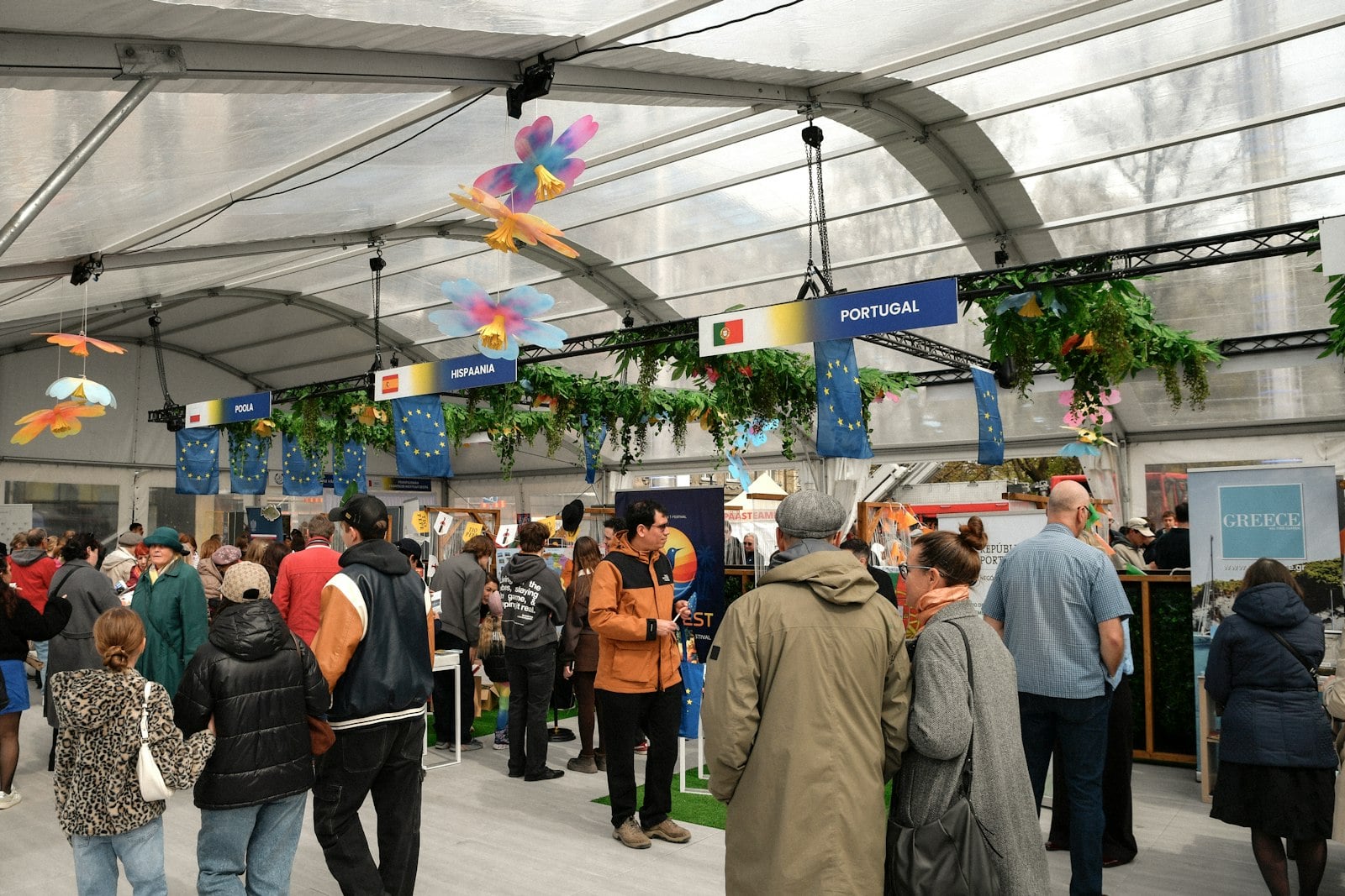 Trade show floor with exhibitors and a branded booth.