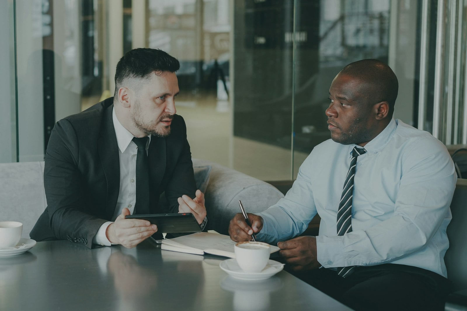 A Private Attaché managing client communications at a desk