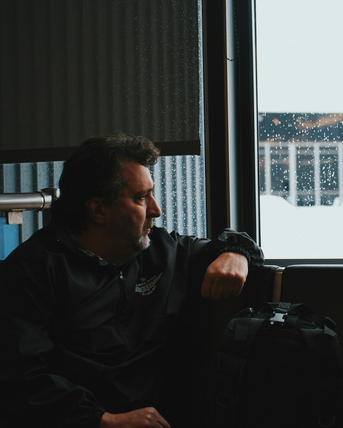 A professional waiting at an airport window